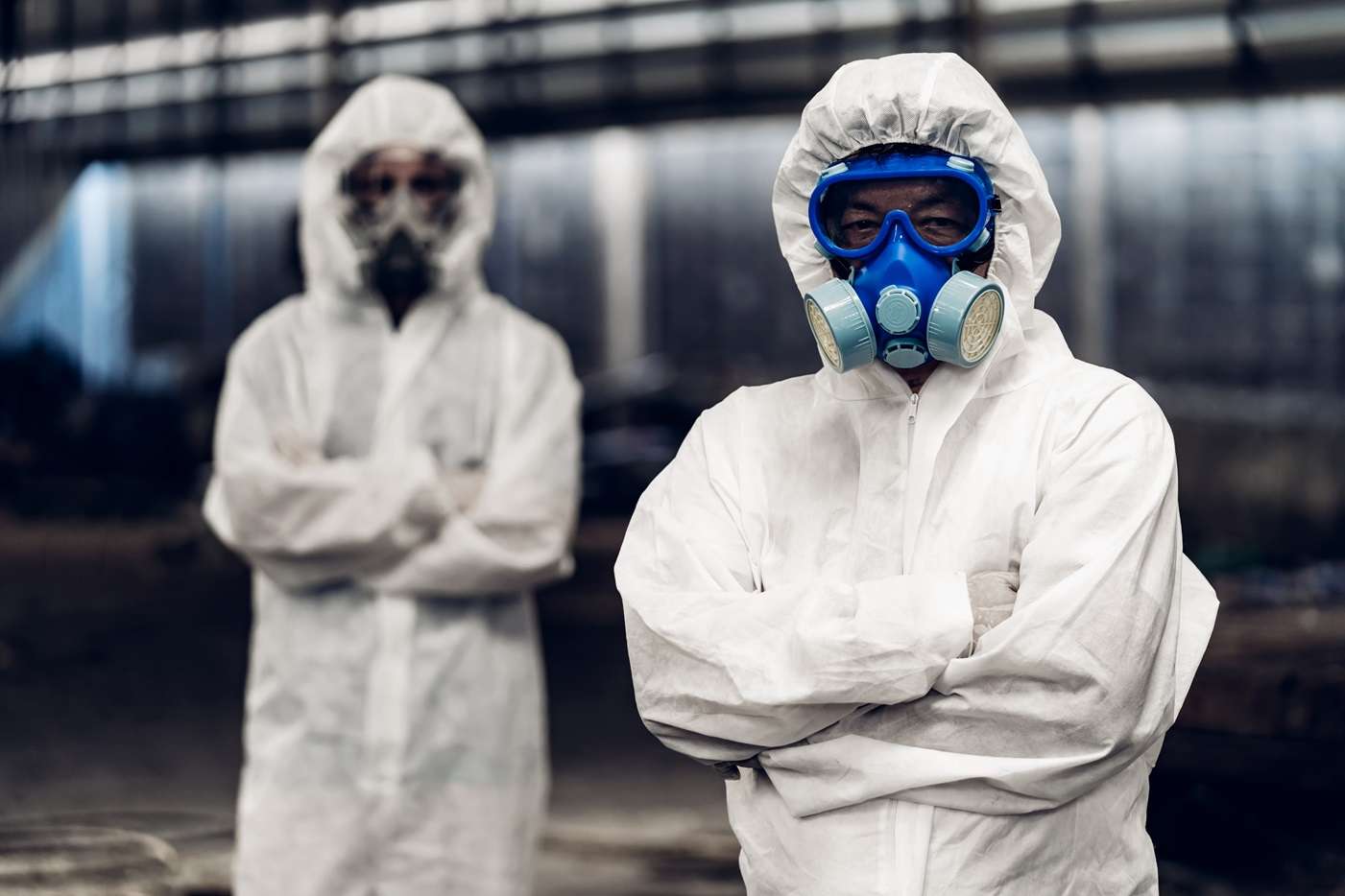 two men in chemical protection suits
